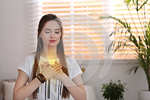 Young woman during self-healing session in room