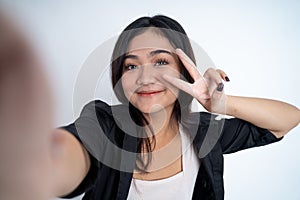 young woman selfie with peace sign finger gesture