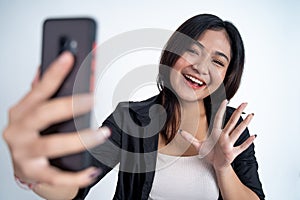 young woman selfie using mobile phone camera with say hello