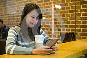 Young woman sending message on cellphone