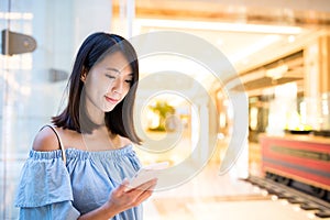 Young Woman sending text message on mobile phone
