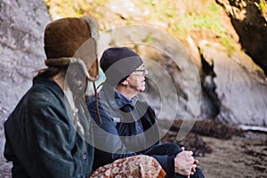 Young woman and senior man on beach