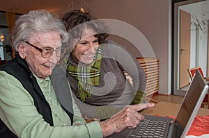 Young woman and senior woman with notebook