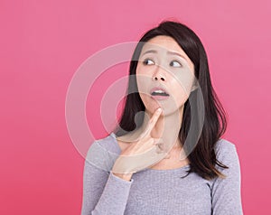 Young woman serious look empty space think ponder minded deep idea  on pink background