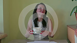 A young woman is served a Cup of coffee in the office.