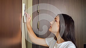 young woman sets parameters on the climate control panel