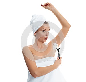 Young woman shaving armpit. Hair removal and skin care concept.