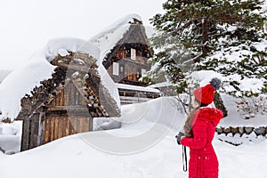 Young woman in Shirakawa-go village in winter, UNESCO world heritage sites, Japan