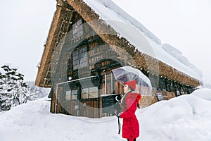 Young woman in Shirakawa-go village in winter, UNESCO world heritage sites, Japan photo