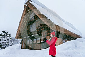 Young woman in Shirakawa-go village in winter, UNESCO world heritage sites, Japan photo