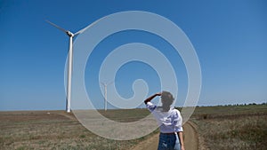 Young woman in a shirt and denim shorts walks