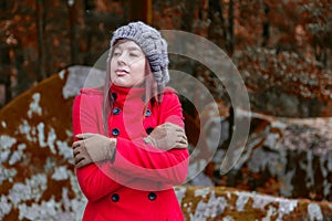 Young woman shivering with cold and embracing herself