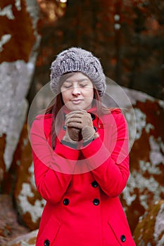 Young woman shivering with cold on a forest