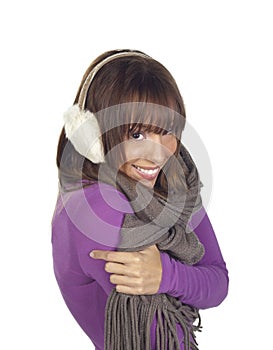 Young woman shivering wearing ear muffs and scarf