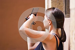 Young woman shooting with phone camera