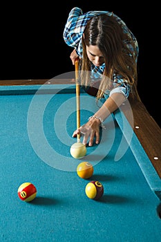 Young woman shooting pool