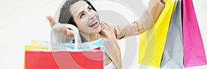 Young woman shopaholic laughing and being happy about bought things