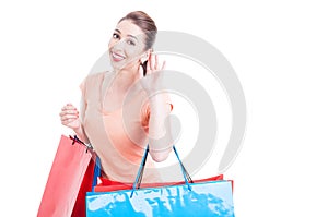 Young woman shopper making cannot hear you gesture