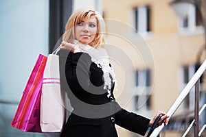 Happy young fashion woman with shopping bags