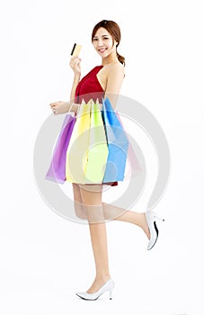 Young Woman with shopping bags and credit card