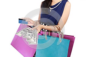 Young woman with shopping bags, money, and credit card