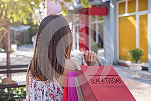 Young woman with shopping bags at shopping mall on black friday, Woman lifestyle concept