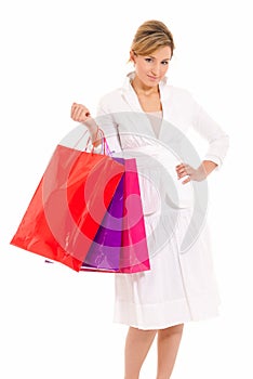 Young woman with shopping bags standing