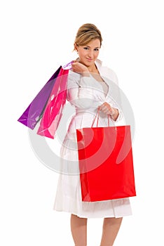 Young woman with shopping bags standing