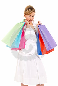 Young woman with shopping bags standing isolated