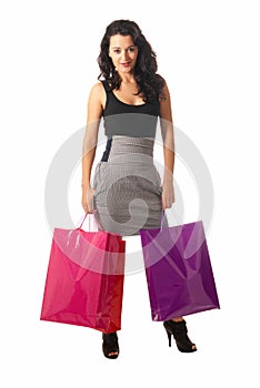 Young woman with shopping bags standing isolated
