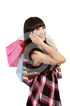 Young woman shopping and calling her friends