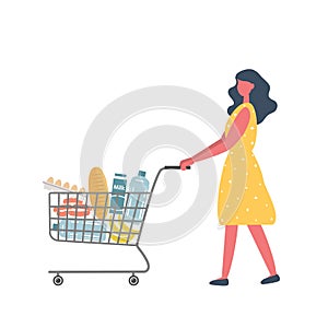 Young woman with shopping cart full of food and drinks