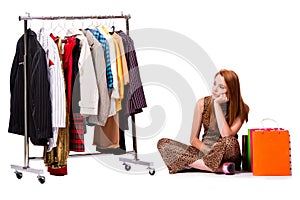 The young woman in shopping concept on white