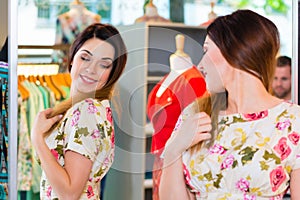 Young woman shopping in fashion department store