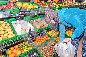 Young woman shopping for fruits in a supermarket