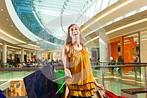 Young woman shopping in mall with bags