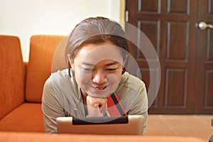Young woman shopping online with credit card
