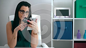Young woman shopping online with credit card at home