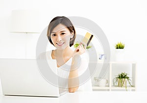Young woman shopping online and paying with credit card