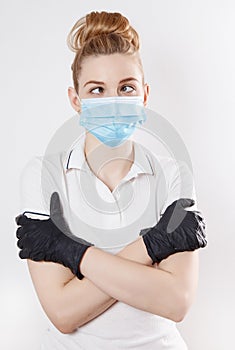 Young woman shopping during a pandemic. Girl in medical mask with basket of products. Shopping times Covid-19