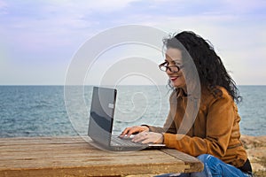 Young woman on shore with computer.3