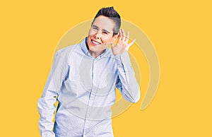 Young woman with short hair wearing business clothes smiling with hand over ear listening an hearing to rumor or gossip