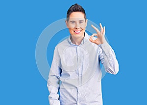 Young woman with short hair wearing business clothes smiling positive doing ok sign with hand and fingers