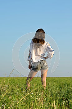 young woman in shorts looks afar