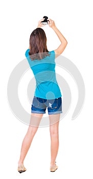 Young woman in shorts photographed something compact camera.