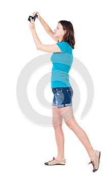 Young woman in shorts photographed something compact camera.