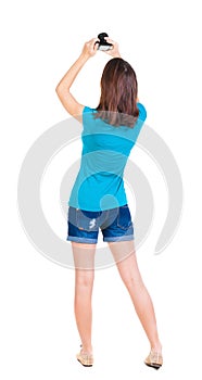 Young woman in shorts photographed something compact camera.