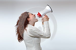 Young woman shouting into a megaphone