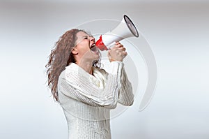 Young woman shouting into a megaphone