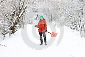Young woman shoveling rural road